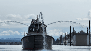 FIre boat leads the the Smile PArade with cannons blasting down the Columbia river